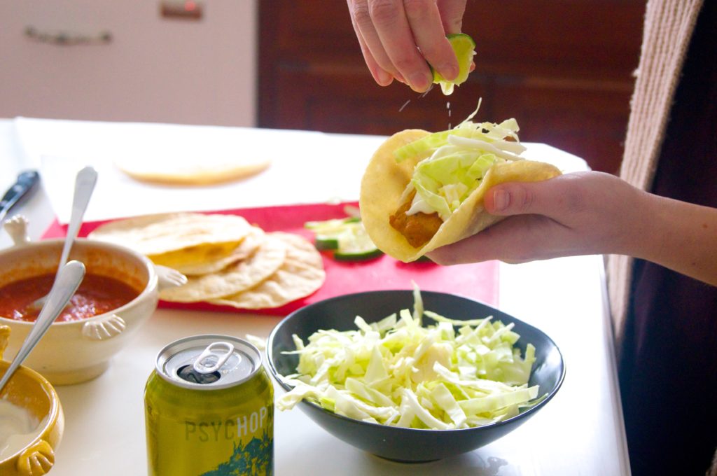 Preparing the Ensenada Fish Taco with a drizzle of lime juice